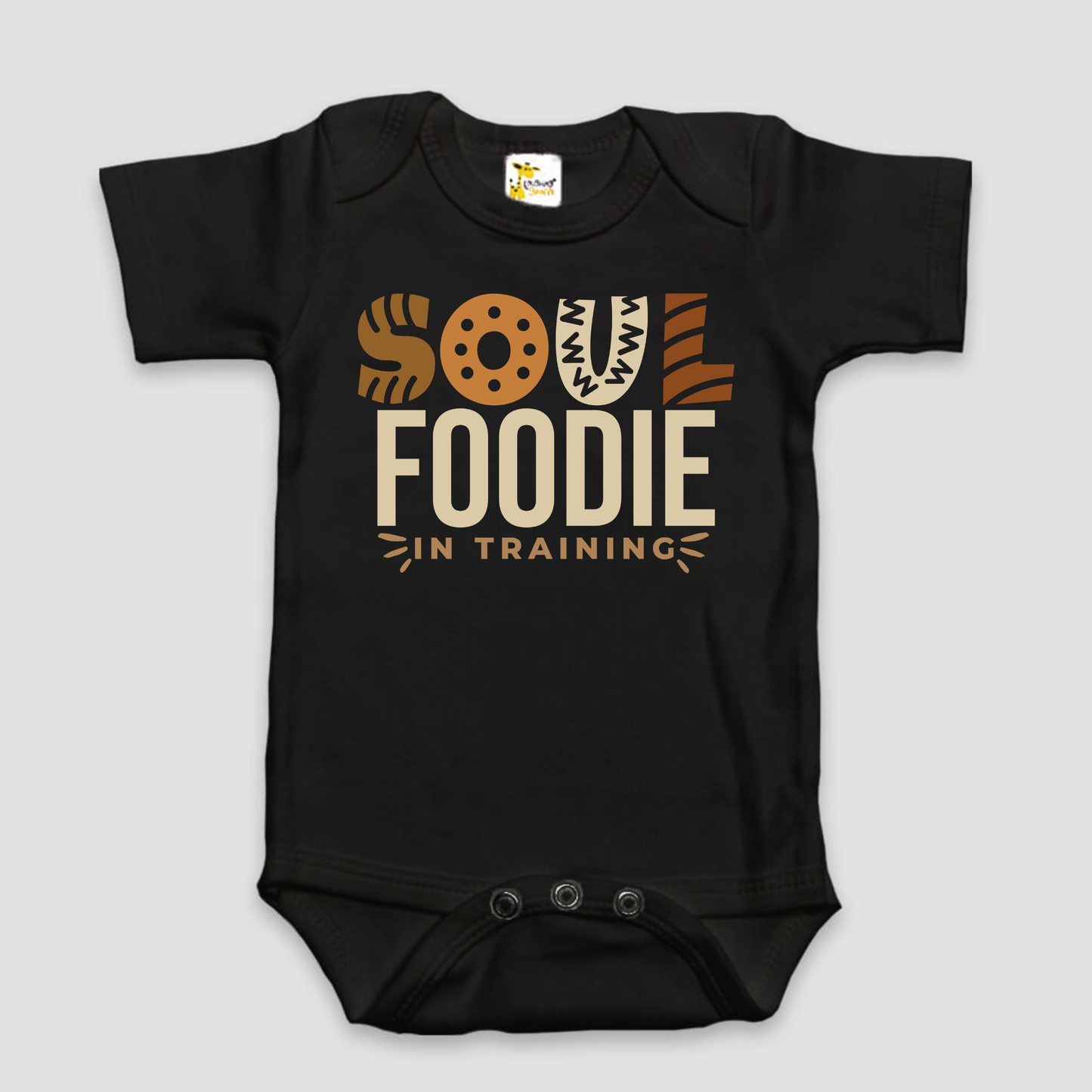 Black baby onesie with 'Soul Foodie in Training' text on a light gray background
