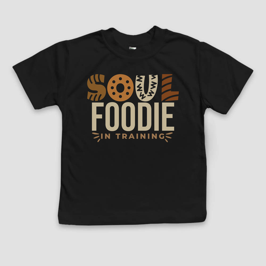 Black t-shirt with 'Soul Foodie in Training' text on a light gray background